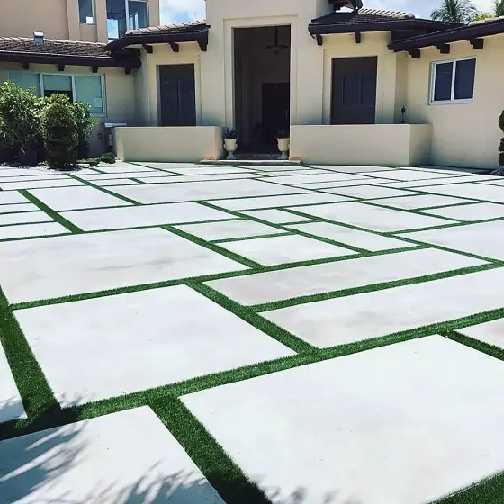Slab driveway with turf joints at a Mediterranean-style home