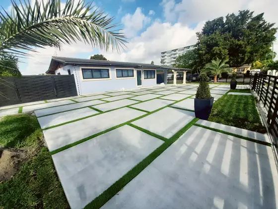 Backyard slabs along a modern fence