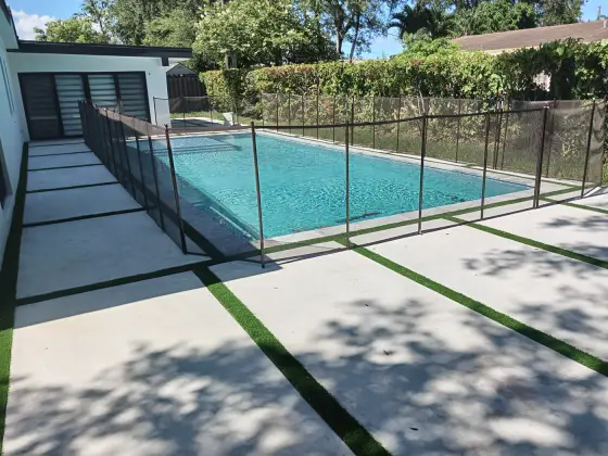 Pool deck slabs with safety fence