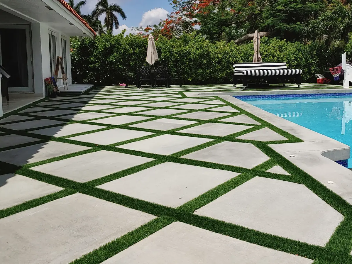 Pool deck of diagonal concrete slabs with turf joints